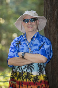 Portrait of Marc Jedel in another Hawaiian shirt and unfortunate hat