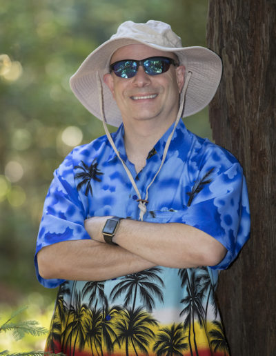 Portrait of Marc Jedel in another Hawaiian shirt and unfortunate hat