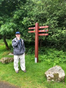 Marc standing in front of confusing signpost